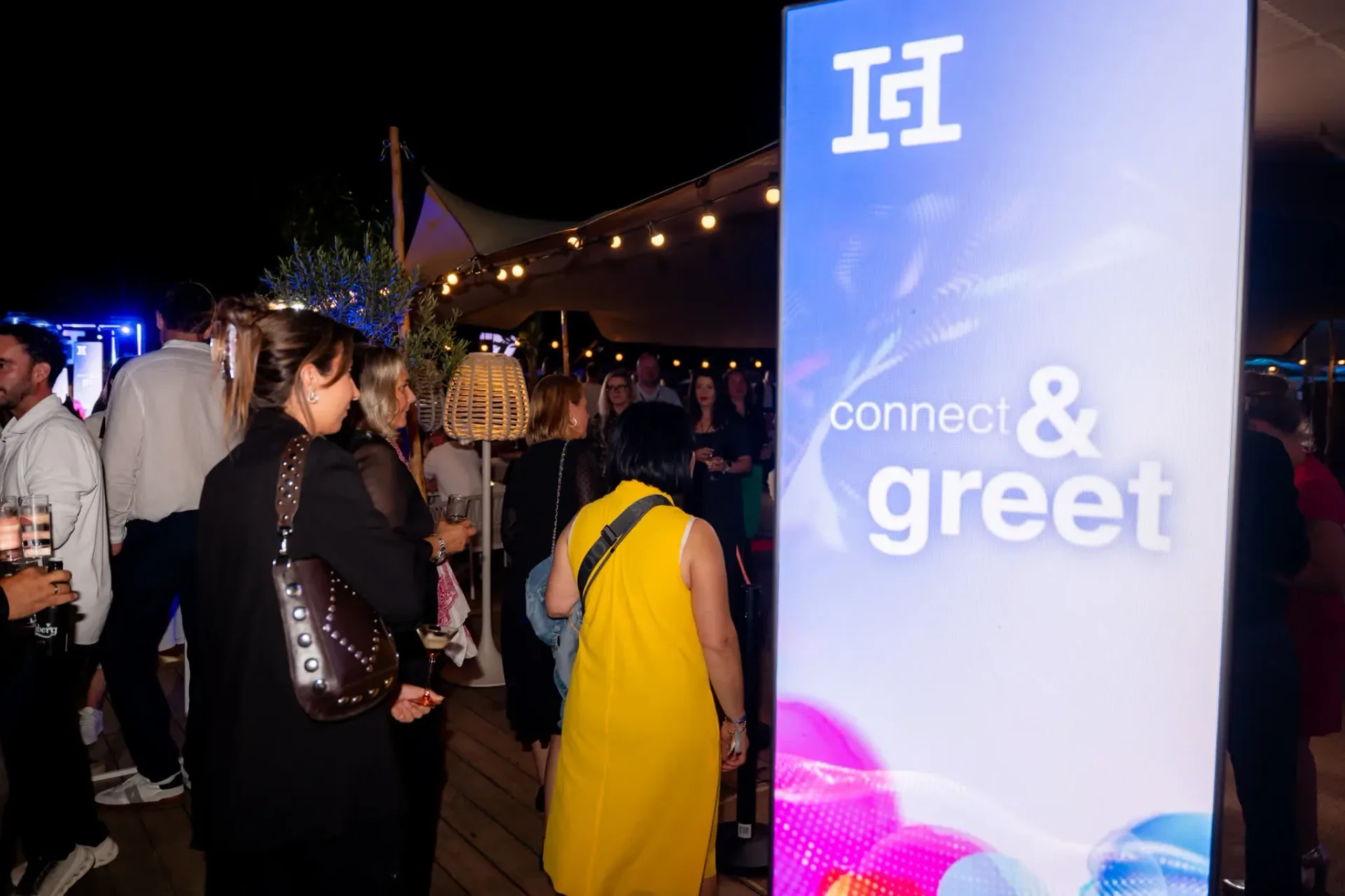 Guests being welcomed in front of the Connect & Greet sign, reception and tasting area of the Heinemann gala evening in Cannes, event photography.